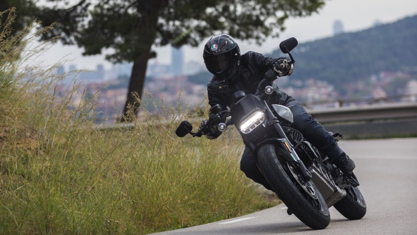 An electric motorcycle riding along a mountain road